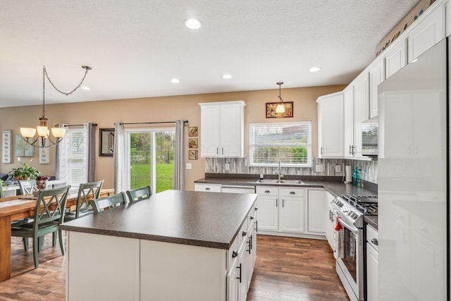 2128 Clay Stone Pl, Reynoldsburg, OH 43068 - kitchen featuring a sink, appliances with stainless steel finishes, dark countertops, a wealth of natural light, and a notable chandelier