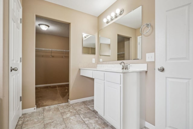 2128 Clay Stone Pl, Reynoldsburg, OH 43068 - full bath with a walk in closet, vanity, and baseboards