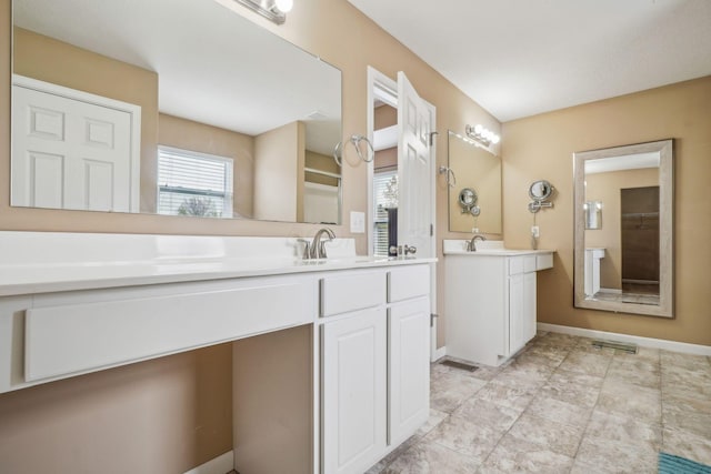 2128 Clay Stone Pl, Reynoldsburg, OH 43068 - bathroom featuring baseboards, visible vents, two vanities, and a sink