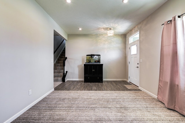 entrance foyer with stairway, baseboards, and recessed lighting