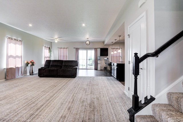 living room featuring stairway, baseboards, recessed lighting, and carpet