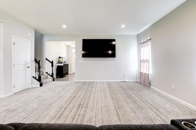unfurnished living room featuring stairway, baseboards, and recessed lighting