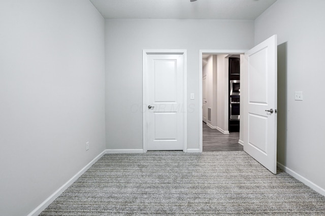 unfurnished bedroom with baseboards and carpet flooring