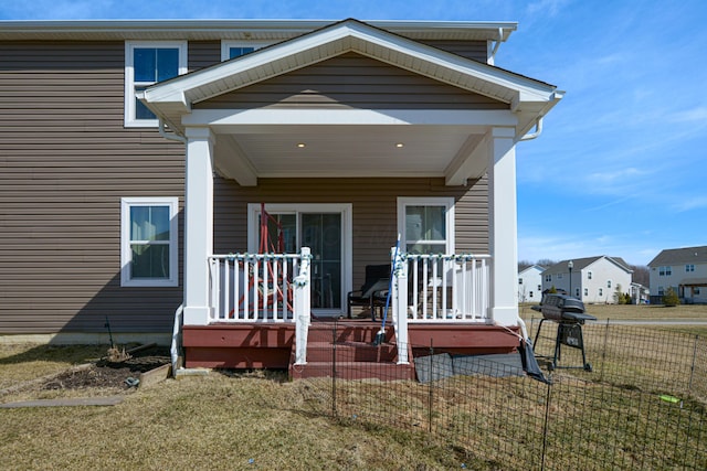 view of exterior entry with a lawn