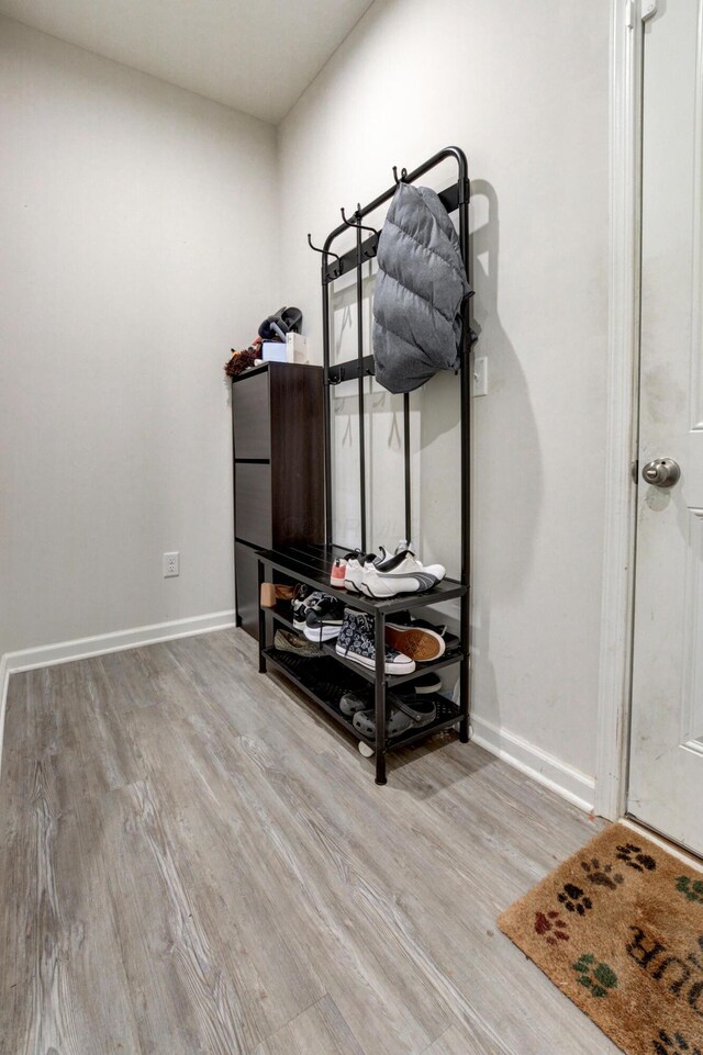 interior space with wood finished floors and baseboards