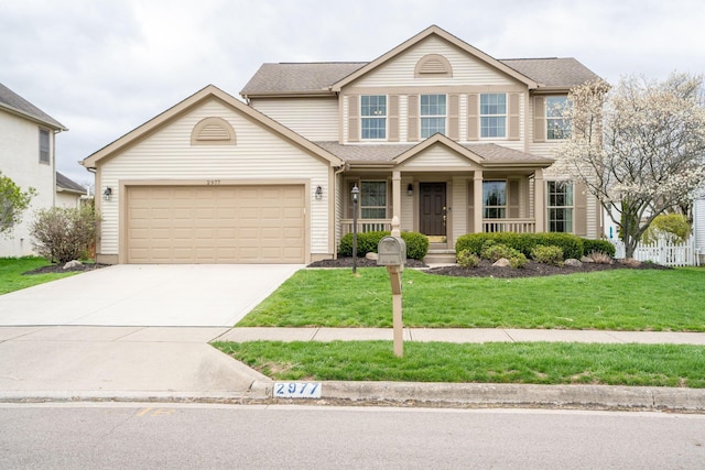 view of front of home featuring an attached garage, driveway, a porch, and a front lawn