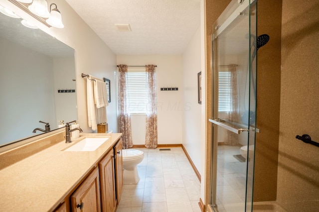 full bathroom with marble finish floor, toilet, vanity, and a stall shower