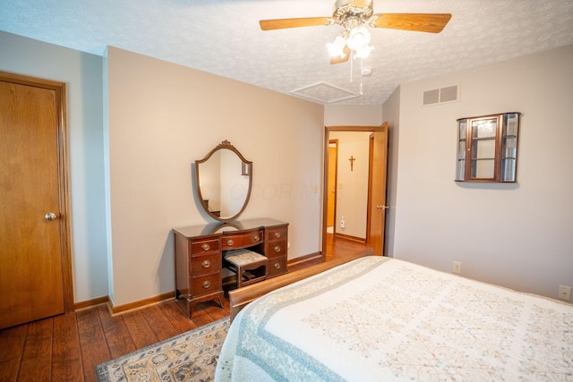 bedroom featuring a ceiling fan, a textured ceiling, wood-type flooring, baseboards, and visible vents