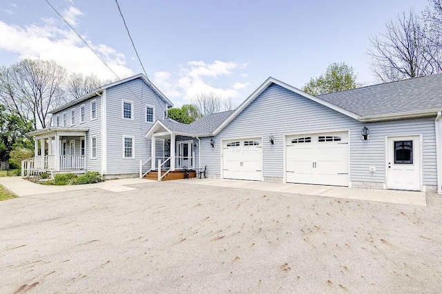 8028 Concord Rd, Johnstown, OH 43031 - view of front of property with an attached garage, driveway, and covered porch
