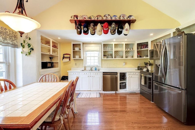 8028 Concord Rd, Johnstown, OH 43031 - kitchen with stainless steel appliances, open shelves, wood finished floors, high vaulted ceiling, and a sink