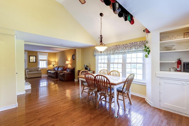 8028 Concord Rd, Johnstown, OH 43031 - dining space with lofted ceiling, wood finished floors, and baseboards