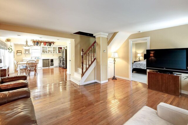8028 Concord Rd, Johnstown, OH 43031 - living area with stairs, wood-type flooring, a bar, and baseboards
