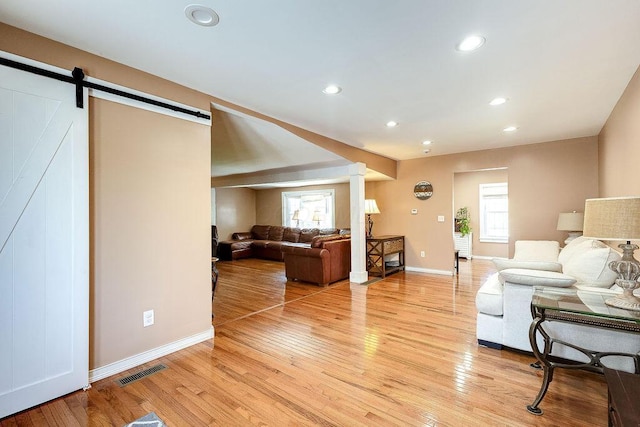 8028 Concord Rd, Johnstown, OH 43031 - living room with ornate columns, light wood-style flooring, baseboards, and recessed lighting