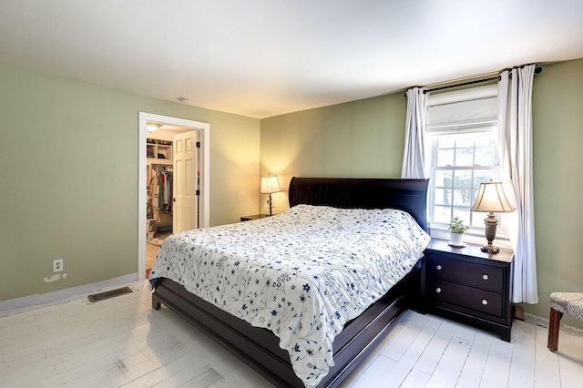 8028 Concord Rd, Johnstown, OH 43031 - bedroom featuring a spacious closet, baseboards, light wood-style floors, and a closet