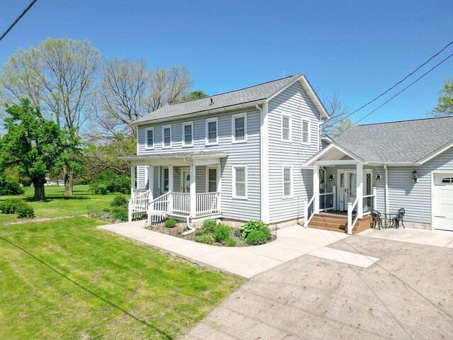 8028 Concord Rd, Johnstown, OH 43031 - view of front of house with covered porch and a front lawn
