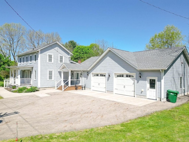 8028 Concord Rd, Johnstown, OH 43031 - view of front facade featuring an attached garage, driveway, covered porch, and a shingled roof