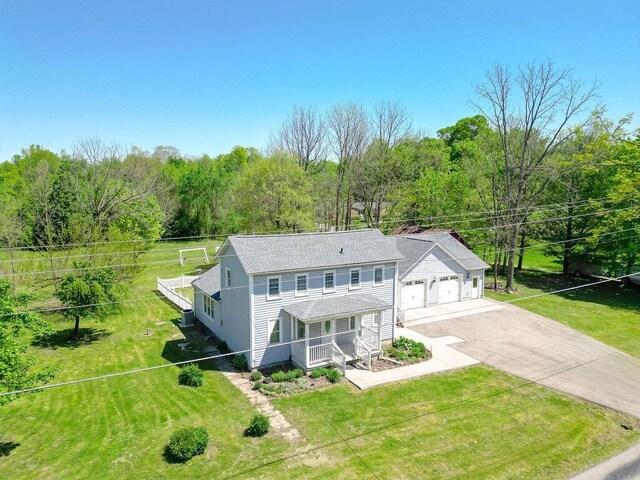 8028 Concord Rd, Johnstown, OH 43031 - view of front of home featuring a porch, roof with shingles, driveway, and a front yard