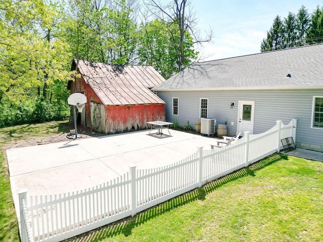 8028 Concord Rd, Johnstown, OH 43031 - rear view of house with a patio area, cooling unit, an outbuilding, a shed, and a shingled roof