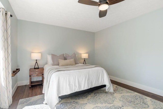 bedroom featuring baseboards, ceiling fan, and wood finished floors