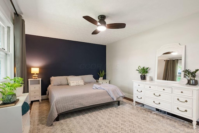 bedroom featuring baseboards and a ceiling fan