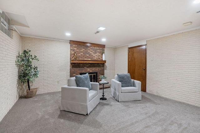 carpeted living room with visible vents, brick wall, and a fireplace