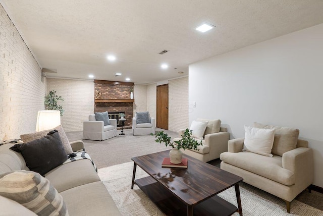 living area featuring carpet floors, a brick fireplace, recessed lighting, and brick wall