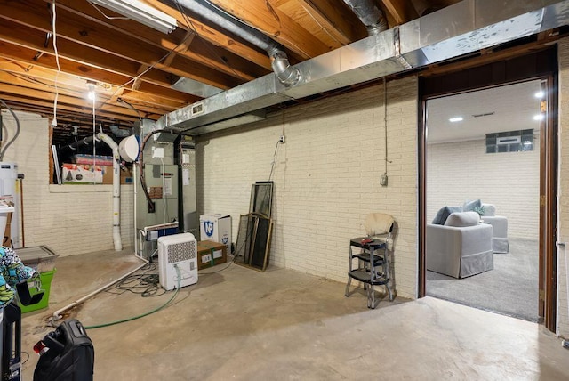 unfinished basement featuring heating unit and brick wall