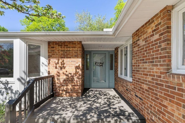 property entrance with brick siding