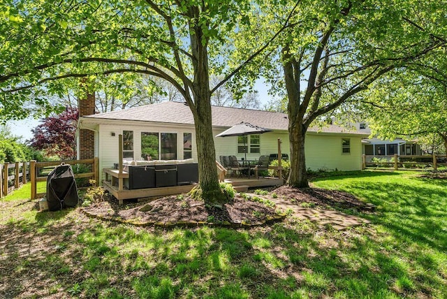 back of house with a wooden deck, a yard, a chimney, and fence
