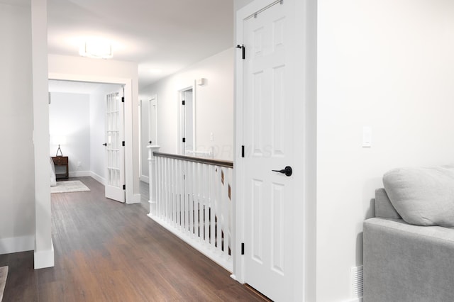 hall with baseboards and dark wood-style flooring