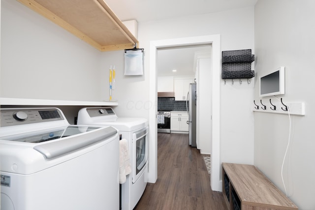 clothes washing area featuring recessed lighting, laundry area, dark wood-style floors, and washing machine and clothes dryer