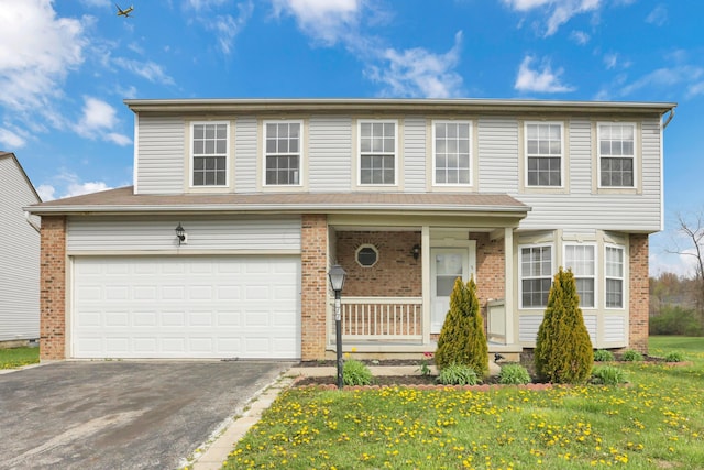 577 Stable St, Pataskala, OH 43062 - traditional-style house with a porch, a front lawn, a garage, brick siding, and aphalt driveway