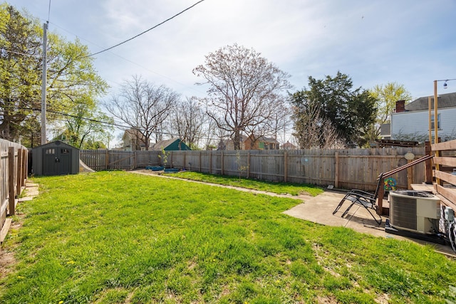 view of yard with a patio area, central air condition unit, a shed, and a fenced backyard