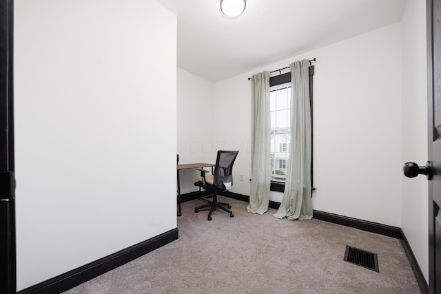 office space with baseboards, visible vents, and carpet floors