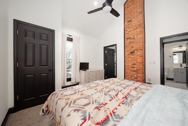 bedroom featuring a ceiling fan, high vaulted ceiling, multiple windows, and ensuite bathroom