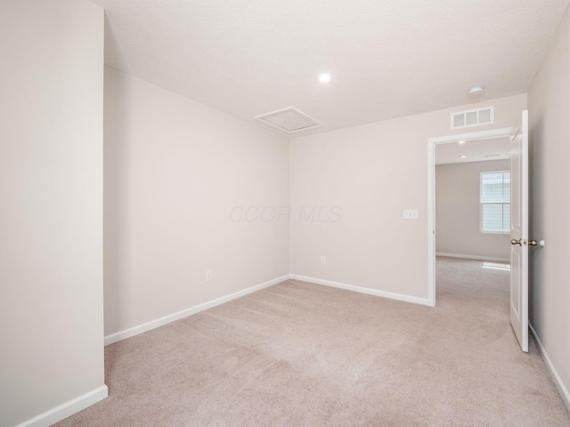 unfurnished room with recessed lighting, visible vents, baseboards, and light carpet