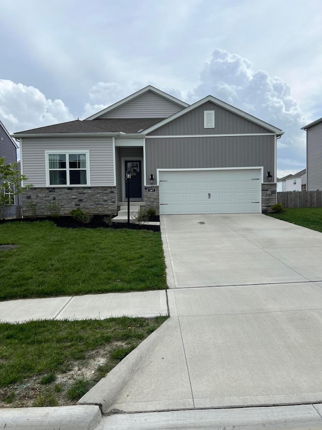 307 Shady Hollow Dr, Commercial Point, OH 43116 - craftsman inspired home with concrete driveway, a front lawn, stone siding, and a garage