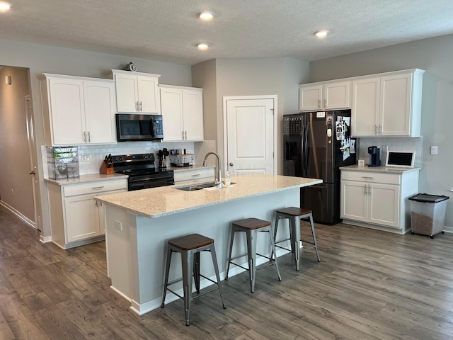 307 Shady Hollow Dr, Commercial Point, OH 43116 - kitchen with dark wood-type flooring, a sink, backsplash, and black appliances