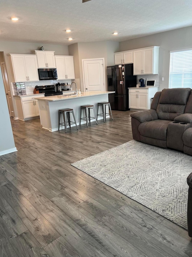 307 Shady Hollow Dr, Commercial Point, OH 43116 - living area with dark wood finished floors, a textured ceiling, and recessed lighting