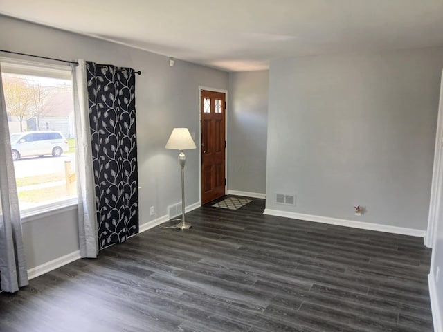 entrance foyer featuring baseboards, dark wood-style flooring, and visible vents
