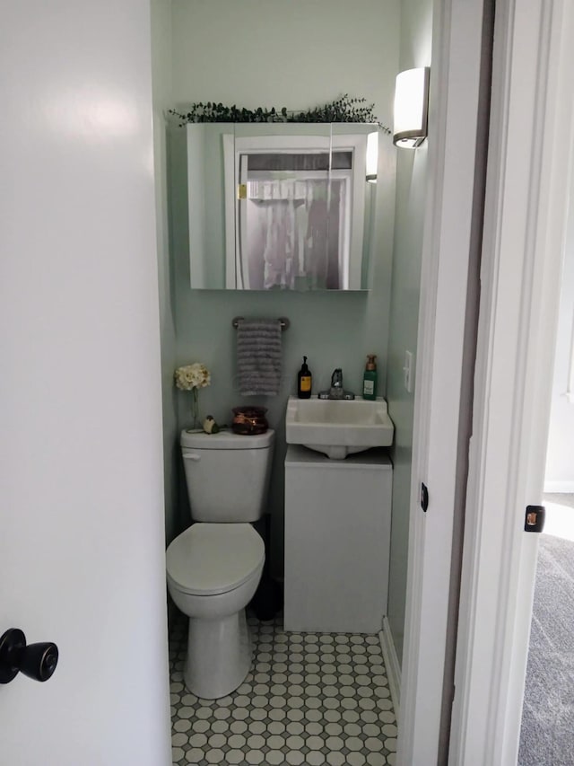 bathroom with tile patterned flooring, toilet, and vanity
