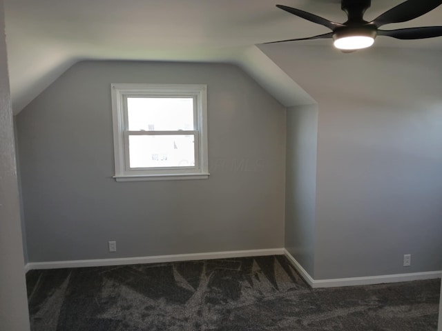 additional living space featuring ceiling fan, vaulted ceiling, baseboards, and carpet