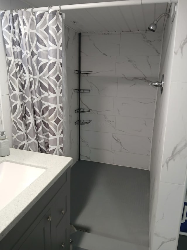 bathroom featuring curtained shower and vanity