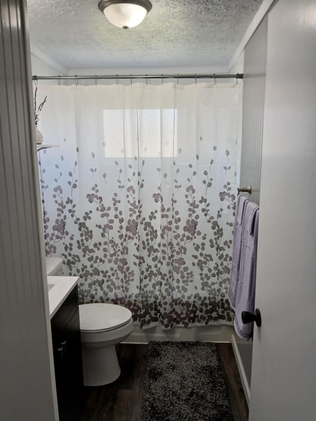 full bathroom with wood finished floors, a textured ceiling, vanity, shower / bathtub combination with curtain, and toilet