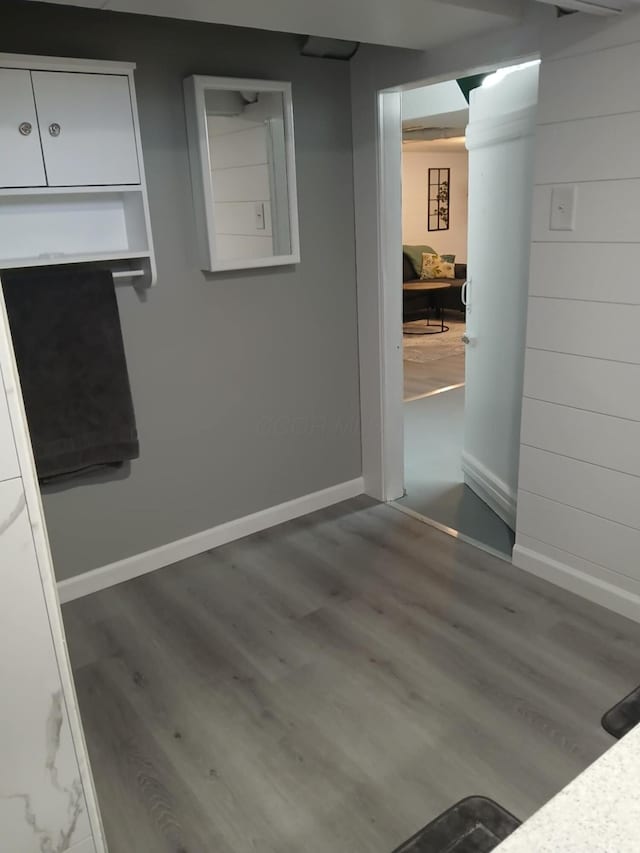 interior space featuring baseboards and wood finished floors
