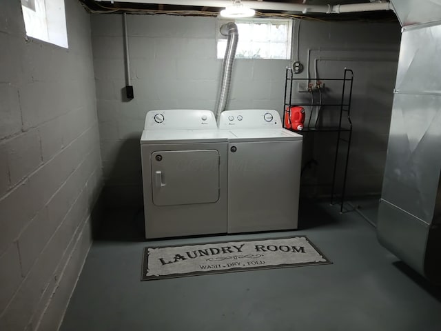 laundry area with washing machine and dryer, heating unit, and laundry area