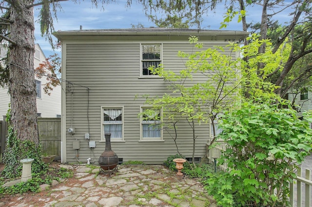 rear view of house featuring fence and a patio area
