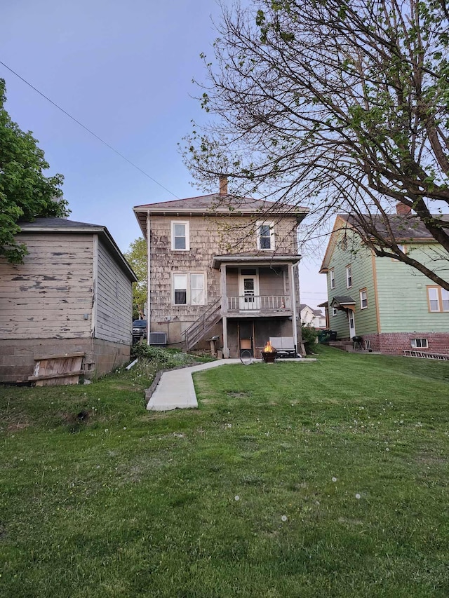 317 N High St, New Lexington, OH 43764 - back of house featuring central air condition unit, a chimney, and a yard