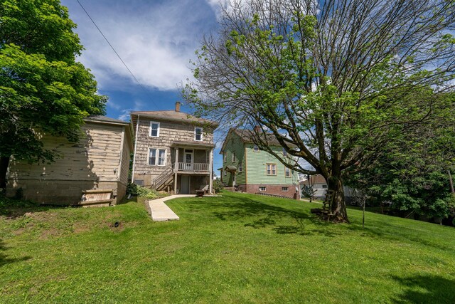317 N High St, New Lexington, OH 43764 - rear view of house with stairs and a lawn
