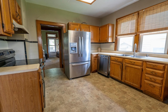 317 N High St, New Lexington, OH 43764 - kitchen featuring stainless steel appliances, under cabinet range hood, a sink, brown cabinets, and light countertops